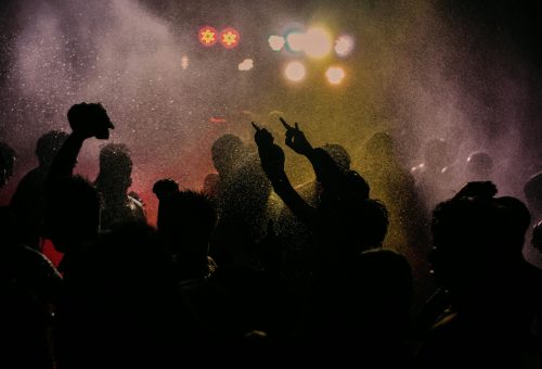 pexels-photo-4651855-4651855 Energetic party scene with silhouetted people and vibrant lights, captured with water effects.